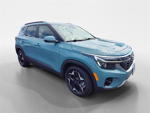 2024 Kia Seltos EX in Pluton Blue — front three-quarter view