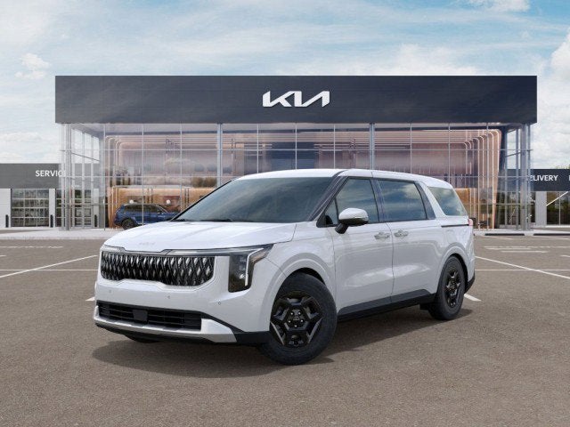 2025 Kia Carnival LX in Snow White Pearl — front three-quarter view